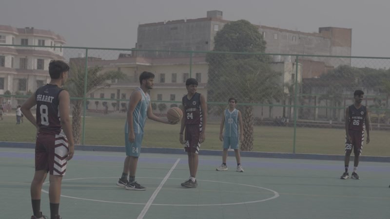 Students playing basketball on the outdoor court