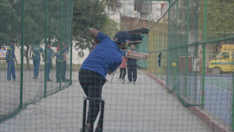 A student batting in the cricket nets, Rohania
