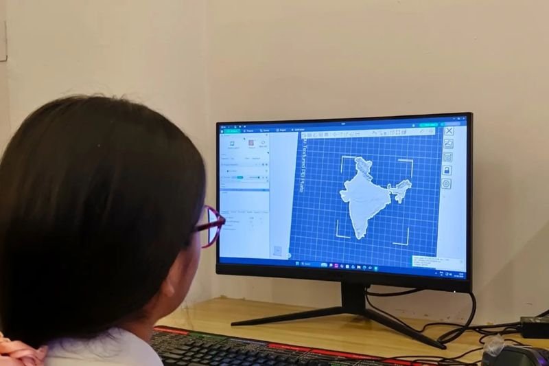 A student designing a model on a computer