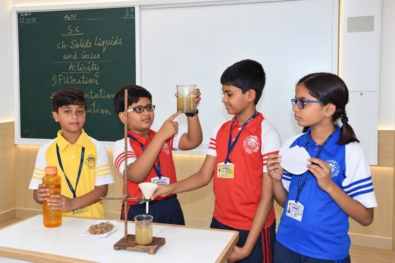 Students testing water filtration in a science activity at Dalimss Sunbeam